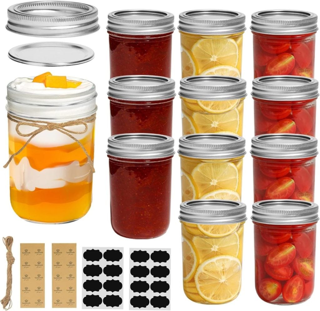 A set of twelve glass jars with metal lids, filled with fruit slices, red preserves, and tomatoes, plus a dessert jar, twine, and labeling stickers shown.