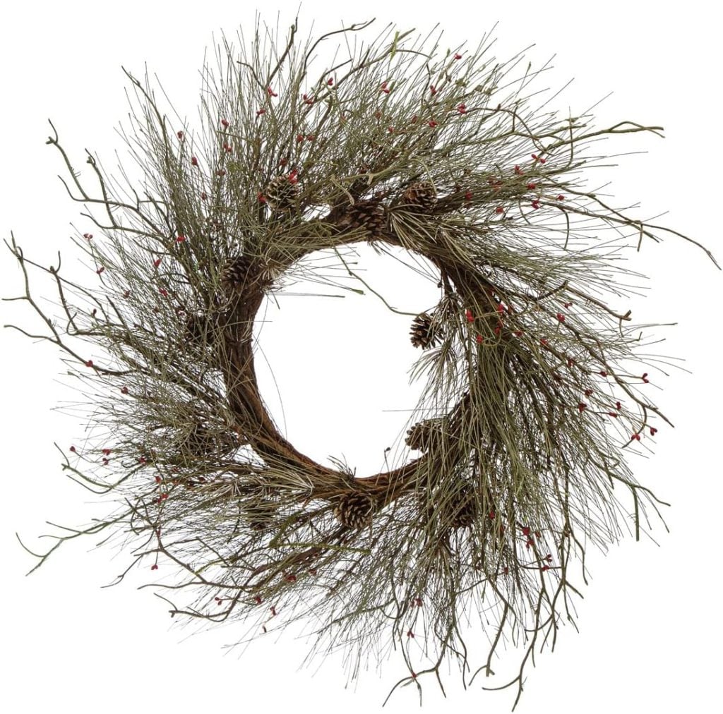 A rustic wreath made of twigs, small pinecones, and red berries arranged in a circular shape against a white background—perfect as charming window art for any home.
