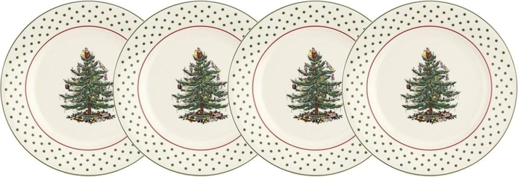 Four ceramic plates featuring decorated Christmas trees in the center and green polka dots along the rims, arranged in a row.