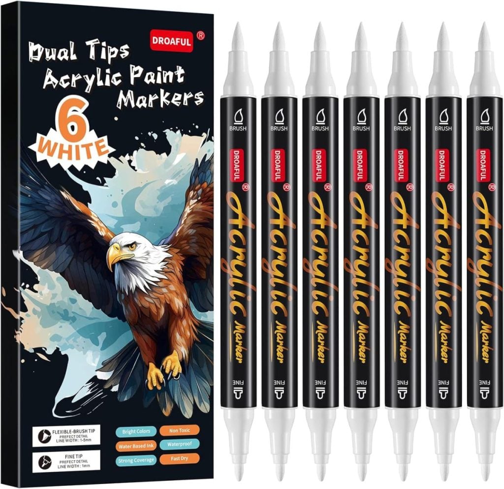 Box of DRAOFUL dual tip acrylic paint markers with six white markers arranged beside the packaging, which features an illustration of an eagle—perfect for creating stunning window art.