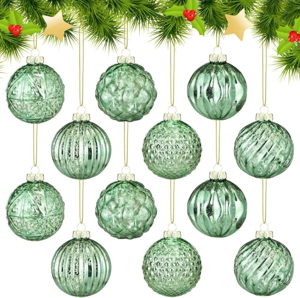 Twelve green glass Christmas ornaments with various textures hang from gold strings beneath pine branches decorated with holly and gold stars.