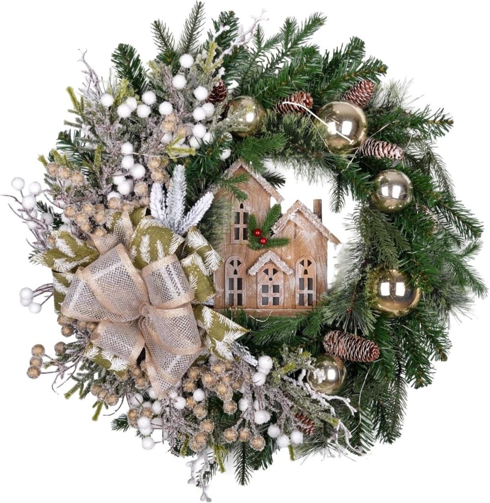 A decorative Christmas wreath with pine branches, gold ornaments, pinecones, a burlap bow, white berries, and a small wooden house ornament in the center—perfect as festive window art for your home.