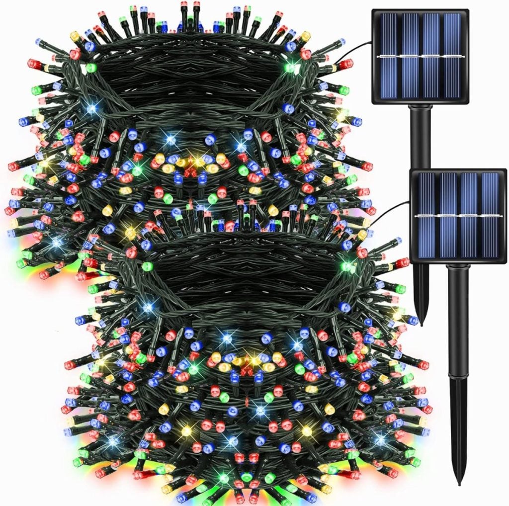 Two bundles of multicolored LED string lights with green wires, each connected to a solar panel with a ground stake—perfect for accenting your Christmas pillow displays or festive outdoor décor.