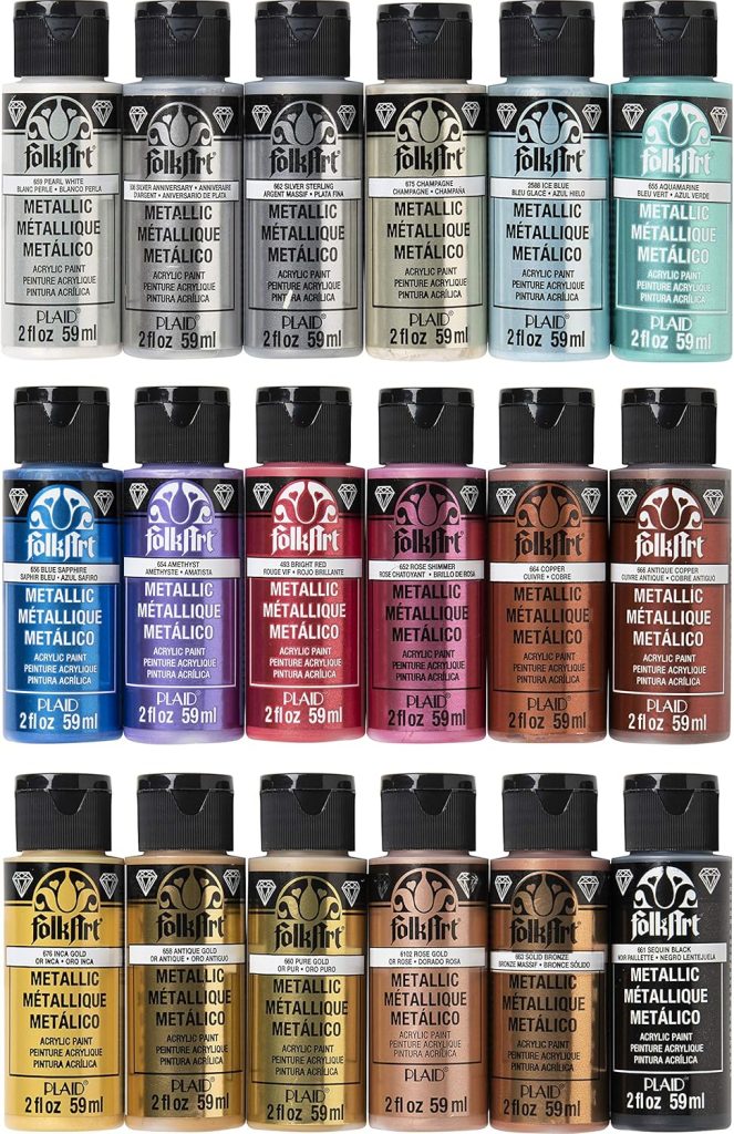 Fifteen bottles of FolkArt metallic acrylic paint in various colors are arranged in three rows against a white background.