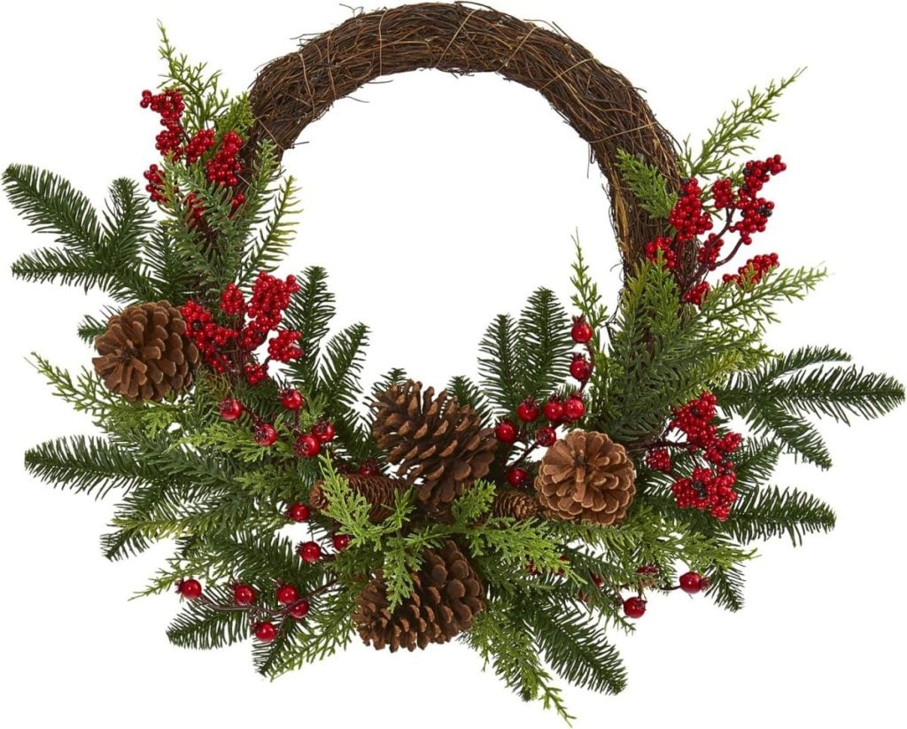 A holiday wreath made of pine branches, red berries, and pine cones, arranged on a circular twig base—a charming piece of window art to brighten your home for the season.