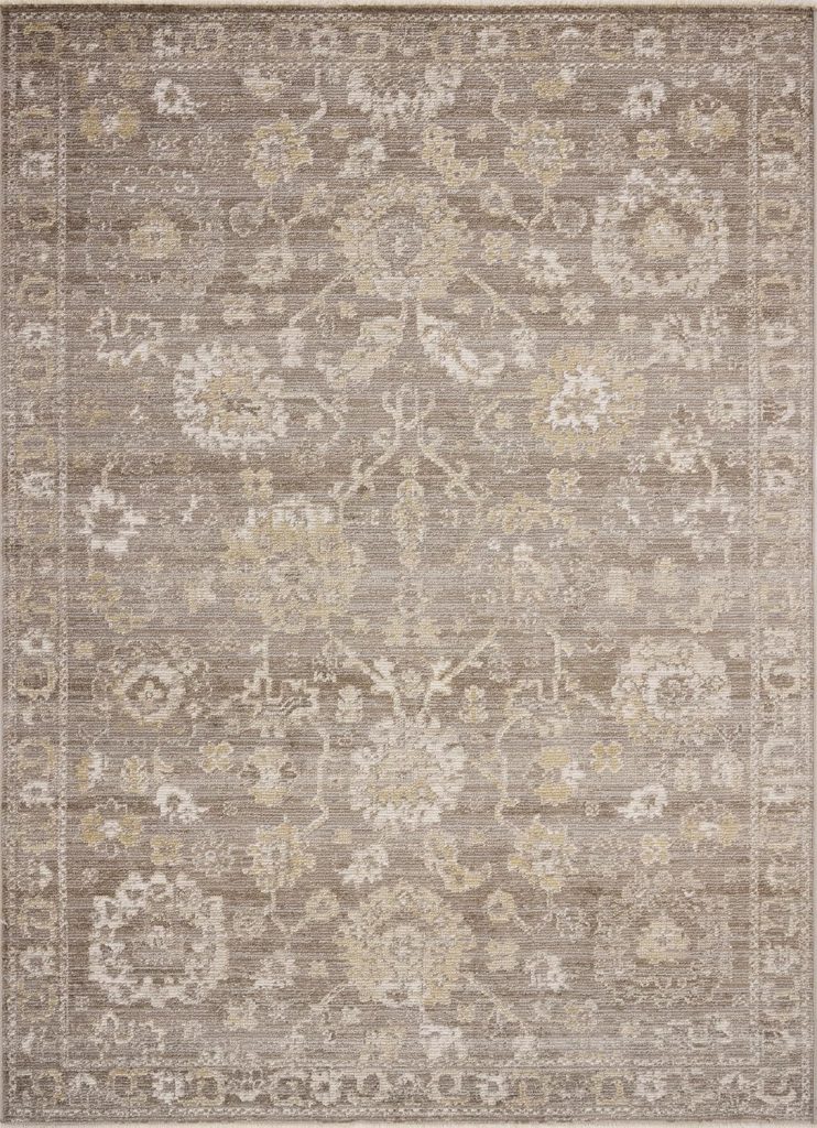 Beige and taupe area rug featuring an intricate, symmetrical floral and medallion pattern with a decorative border.