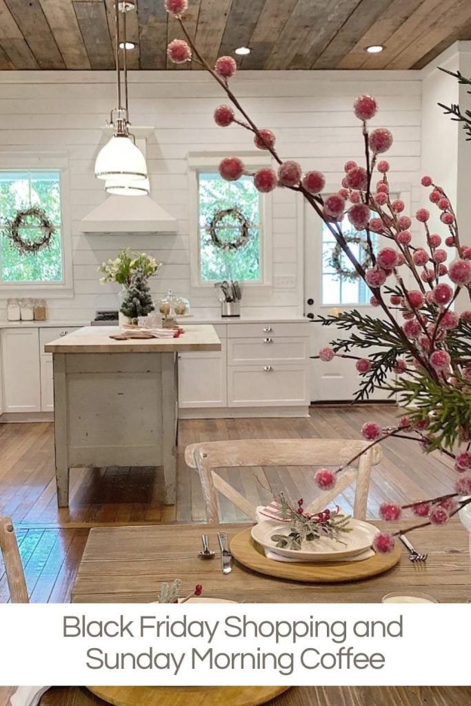 Bright kitchen with white cabinets and wooden accents, set dining table with pink floral centerpiece, and text: "Black Friday Shopping and Sunday Morning Coffee.