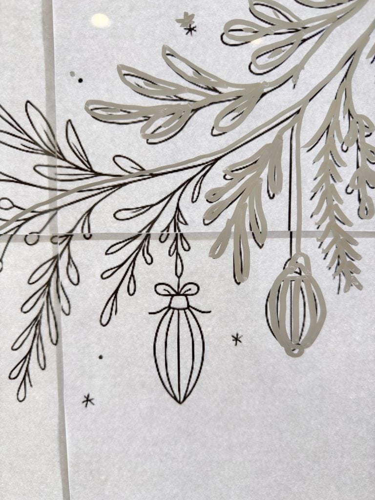 Black line drawing of pine branches with hanging ornaments and small stars on a white background.