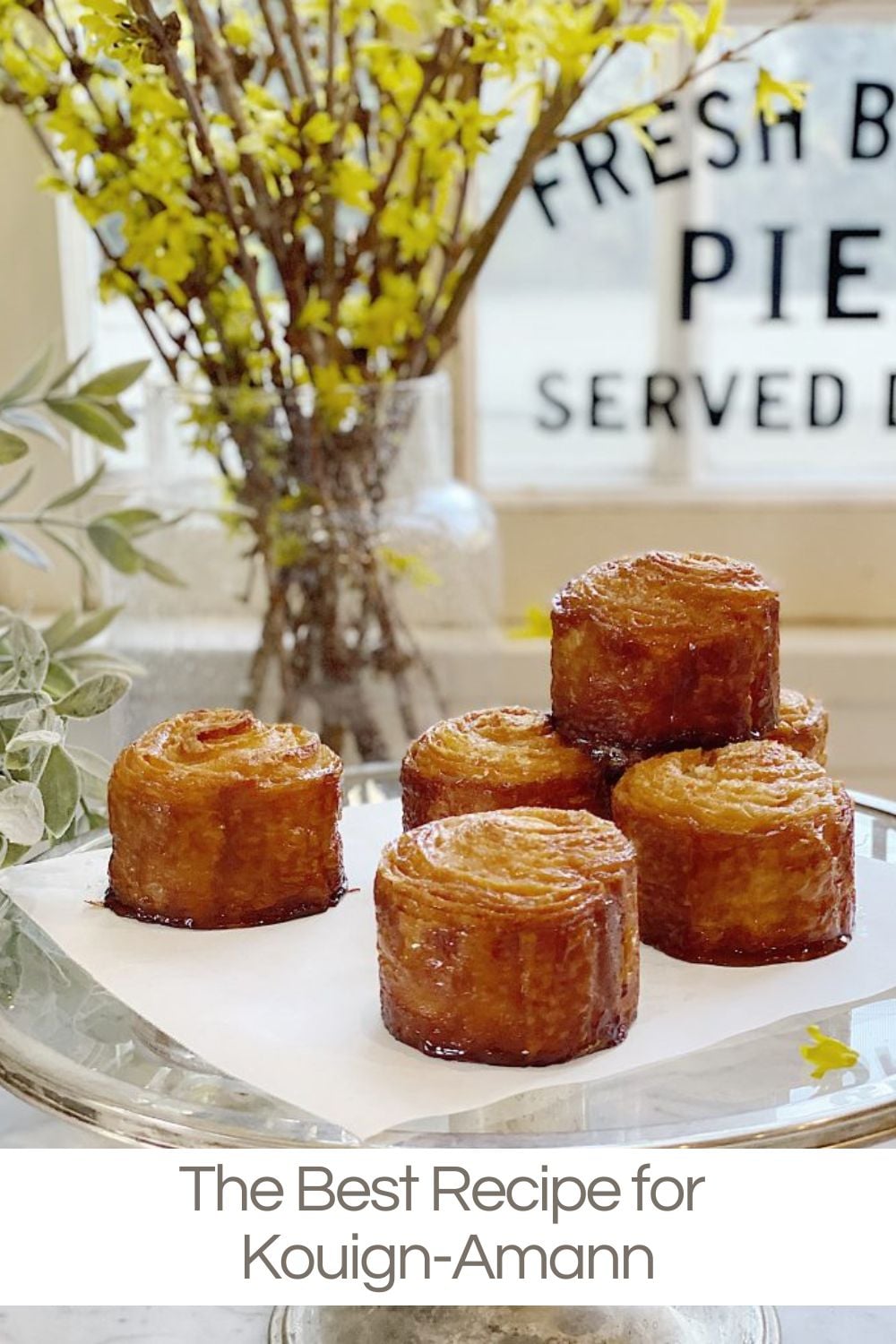 Kouign-amann is a French pastry with a croissant-like dough, laminated with butter and sugar for a flaky, decadent treat with a caramelized outer crust.