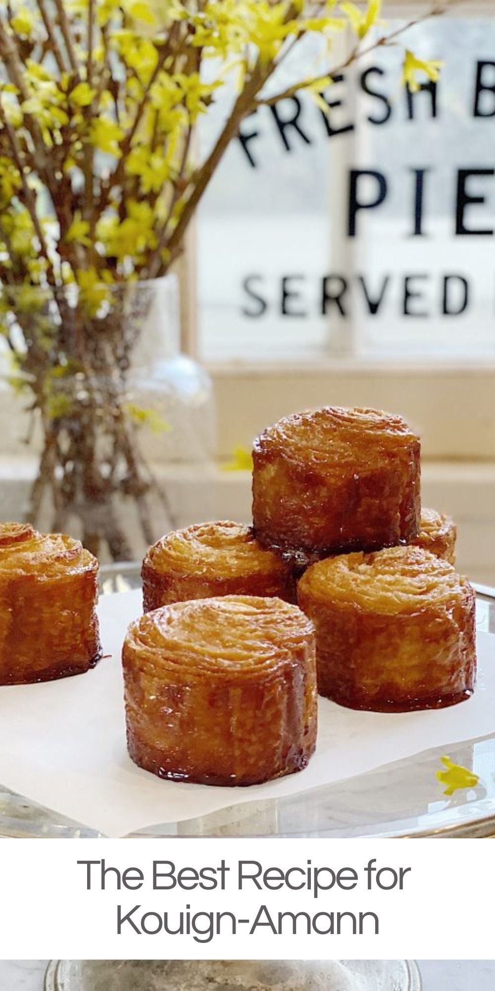 Kouign-amann is a French pastry with a croissant-like dough, laminated with butter and sugar for a flaky, decadent treat with a caramelized outer crust.