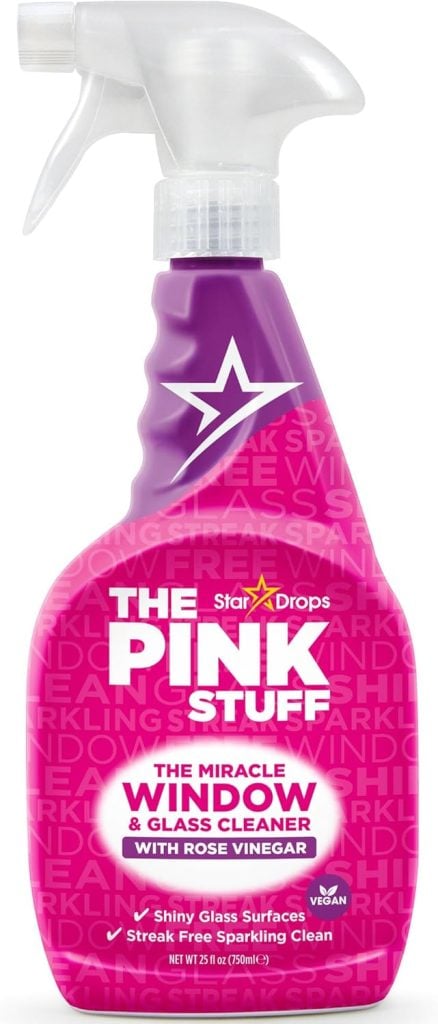 A pink spray bottle of The Pink Stuff Miracle Window & Glass Cleaner with Rose Vinegar by Star Drops, labeled for shiny, streak-free, vegan cleaning.