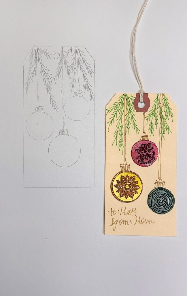 A gift tag with three colored ornaments and pine branches, labeled "to: Matt from: Mom," next to a pencil sketch of the same design.
