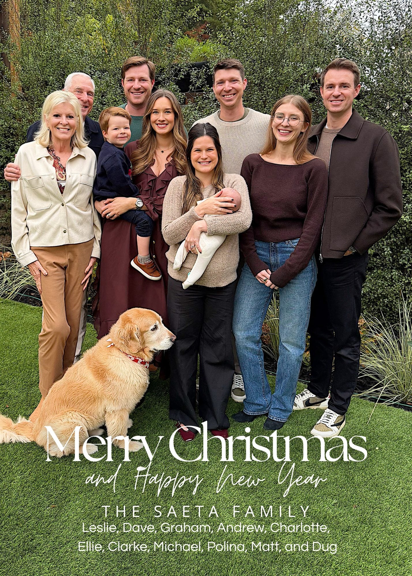 The Saeta family of ten, including a baby and a dog, poses together outdoors in a garden, smiling for a group holiday photo with text reading &ldquo;Merry Christmas and Happy New Year.&rdquo;.