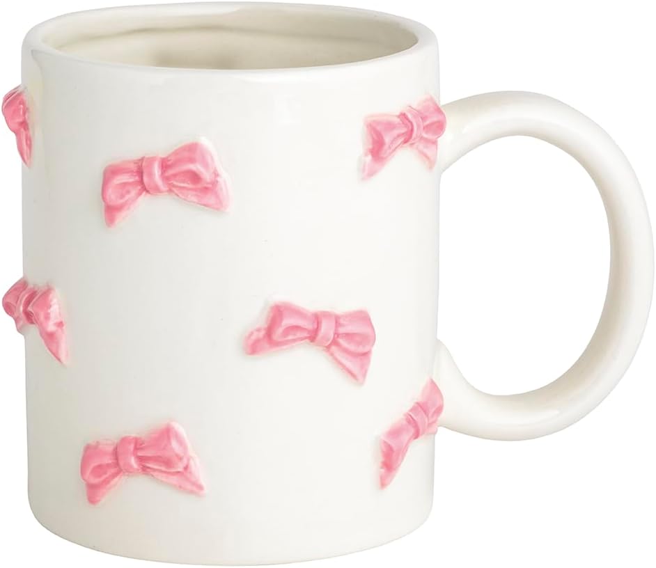 A white ceramic mug decorated with raised pink bow designs.