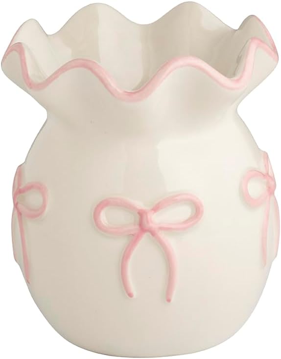 White ceramic vase with a ruffled rim and pink bow designs on the sides.