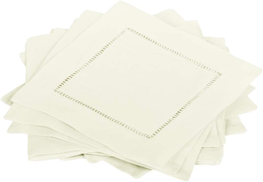 A stack of beige cloth napkins with decorative hemstitching around the border.