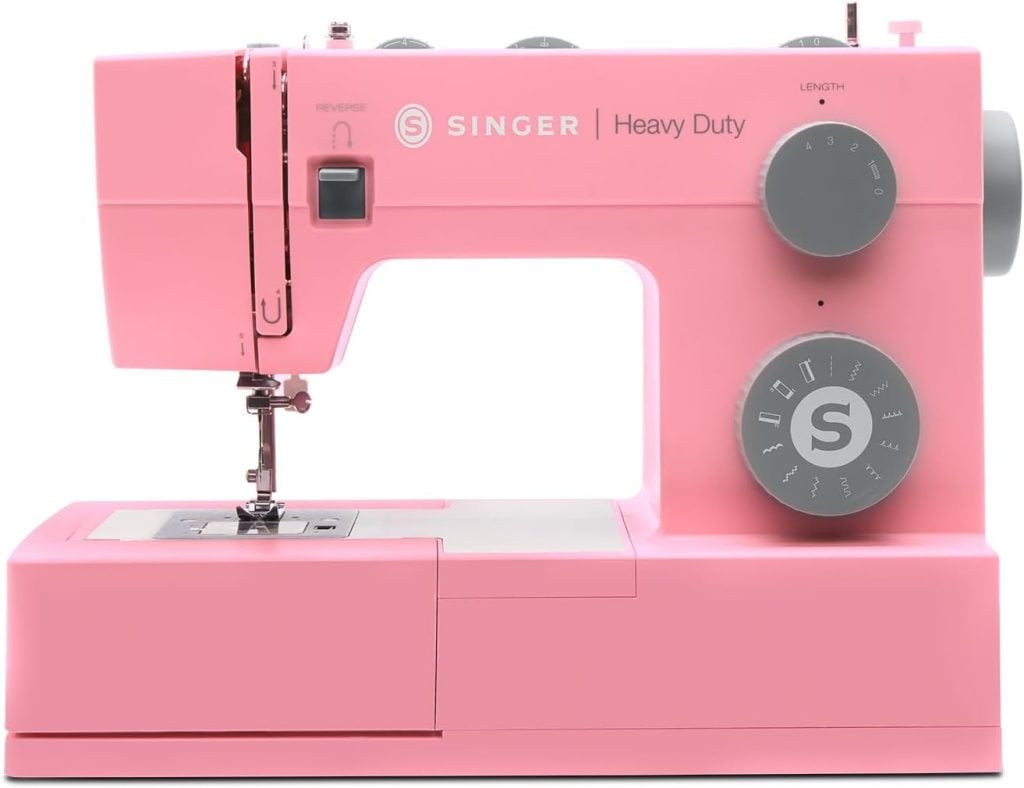 A pink Singer Heavy Duty sewing machine with dials for stitch selection and adjustment, displayed against a white background.
