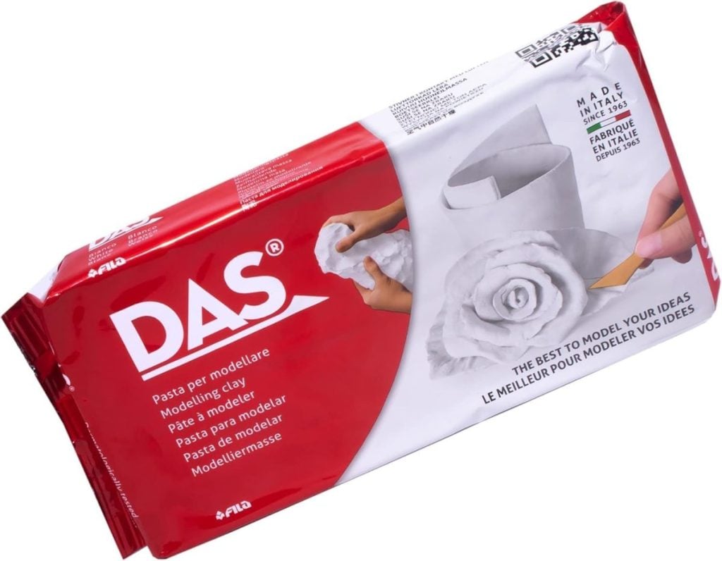 A red and white package of DAS modeling clay showing a sculpted white rose and the text "The best to model your ideas" on the front.