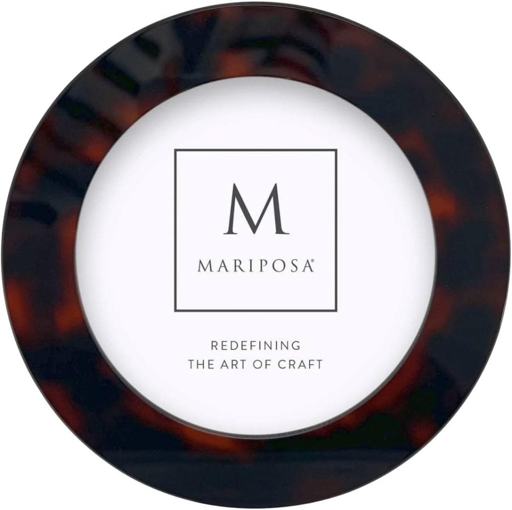 A round plate with a dark rim and "MARIPOSA" logo in the center, above the text "REDEFINING THE ART OF CRAFT.