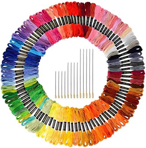 A circular arrangement of embroidery floss skeins in various colors surrounds a set of nine embroidery needles, perfect for crafting Valentine Heart Ornaments.