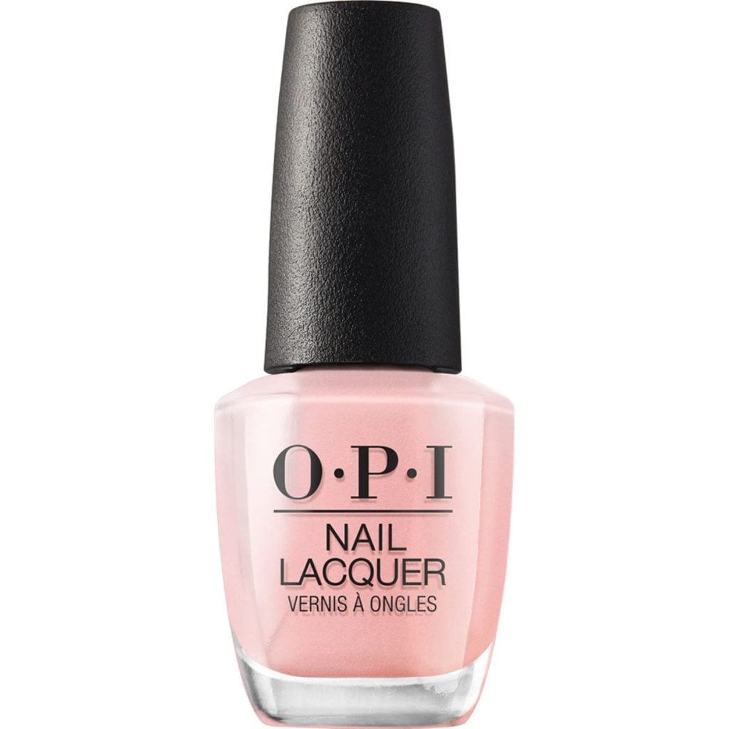 A bottle of OPI Nail Lacquer in a light pink shade with a black cap and product label on the front.