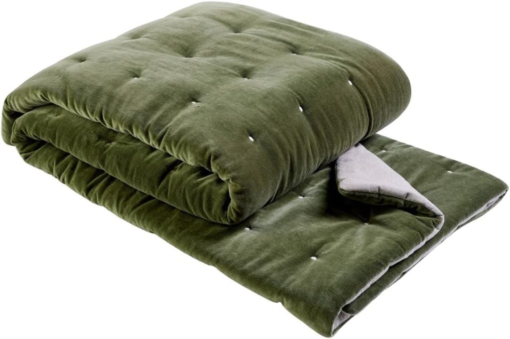 A folded, olive green quilted blanket with a soft, velvety texture and a contrasting light gray underside.