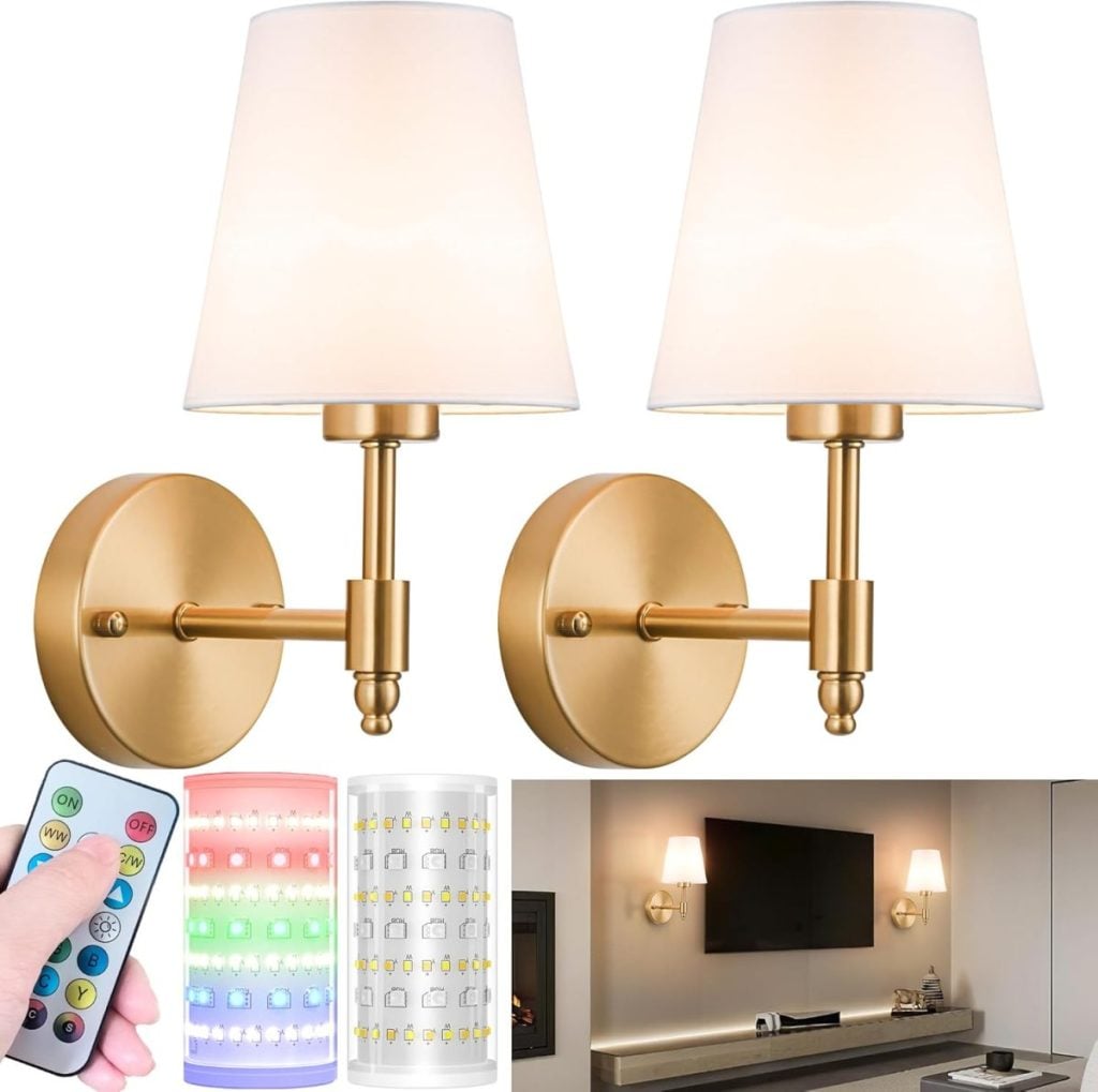 A pair of gold wall sconces with white lampshades, featuring LED light options and a remote control&mdash;an elegant way to brighten your living space. Add installing these stylish sconces above your TV to your list of Things To Do This Year.