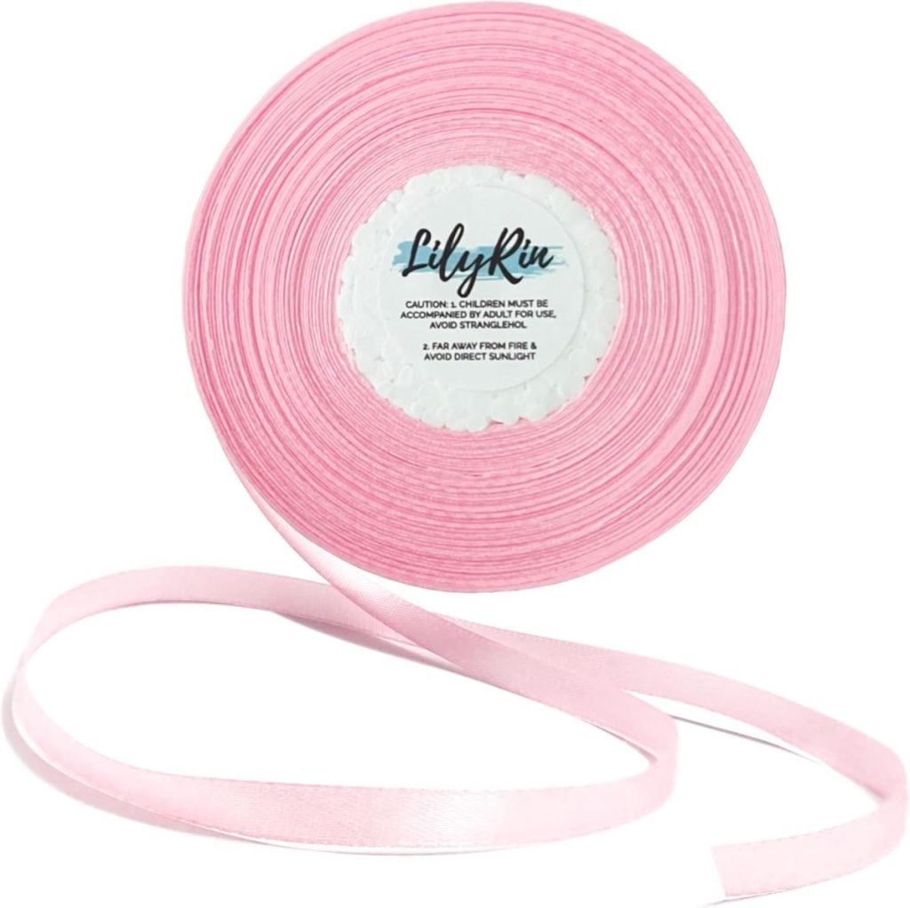 A roll of light pink satin ribbon with "LilyRin" branding on the label, partially unrolled on a white background.