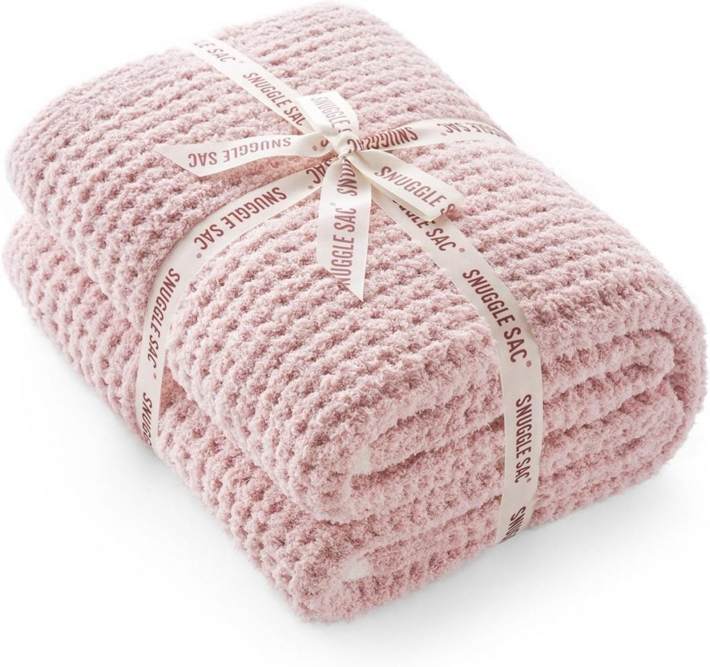 A stack of pink towels tied with a white ribbon.