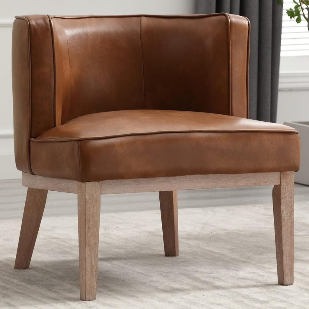 A brown leather accent chair with light wooden legs sits on a light-colored rug in a modern room with white walls and a window.
