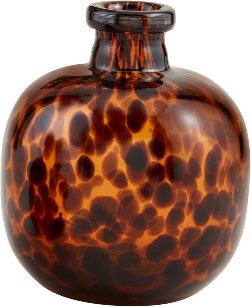 Round amber glass vase with a narrow neck and a mottled brown and black pattern on its surface.