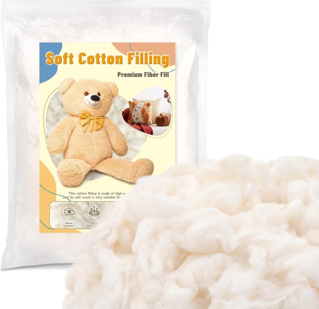A bag of soft cotton filling with packaging showing a stuffed teddy bear and fiber fill, alongside a pile of loose cotton fiber.
