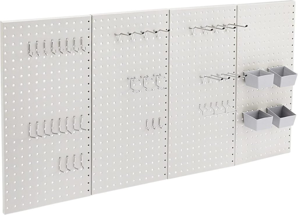 A white pegboard wall panel with various metal hooks and three small gray storage bins attached, designed for organizing tools or supplies.