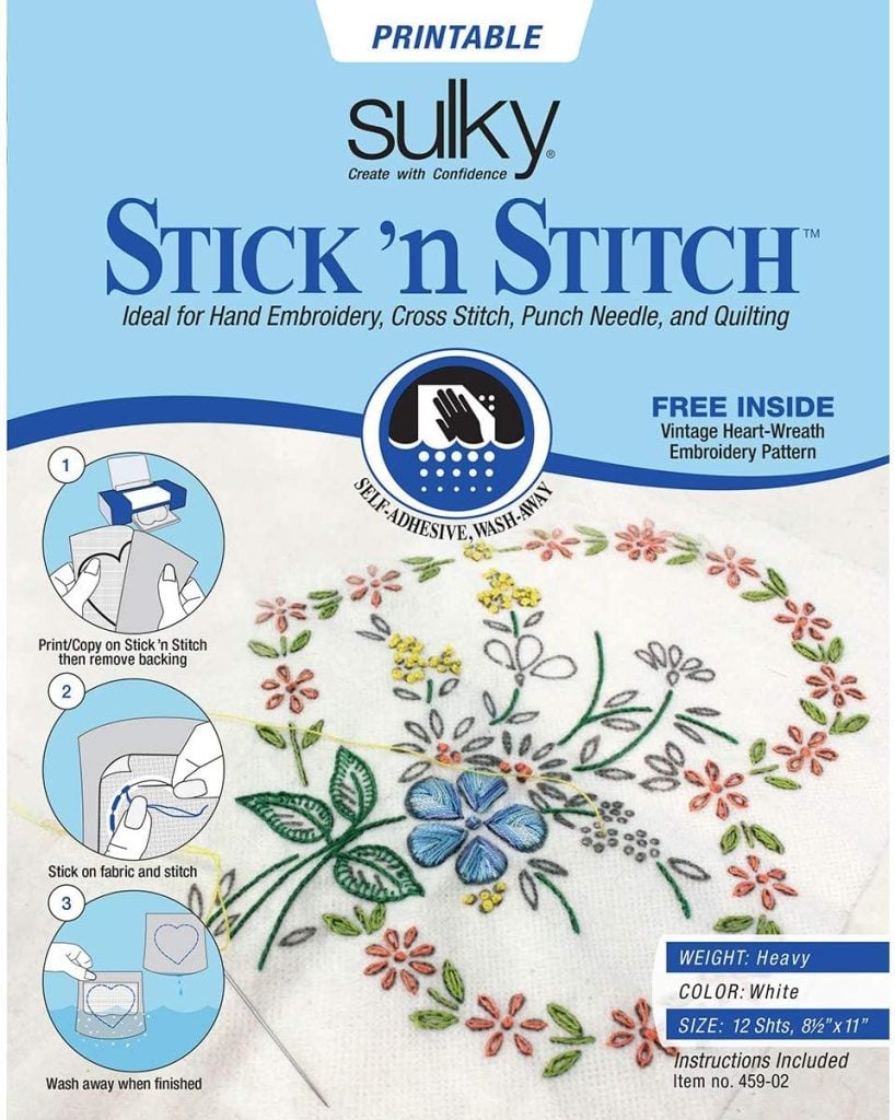 Package of Sulky Stick 'n Stitch printable sheets for embroidery, showing instructions and a floral embroidery pattern example on fabric.