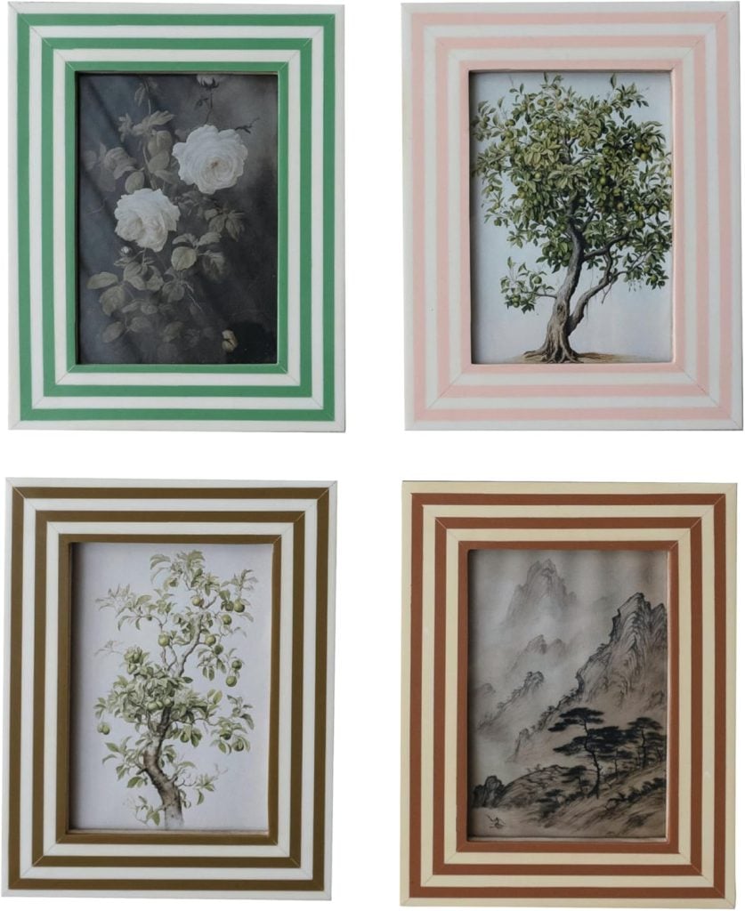 Four framed paintings: a white rose bouquet, a leafy tree, another leafy tree, and a mountain landscape, each with different colored striped frames.