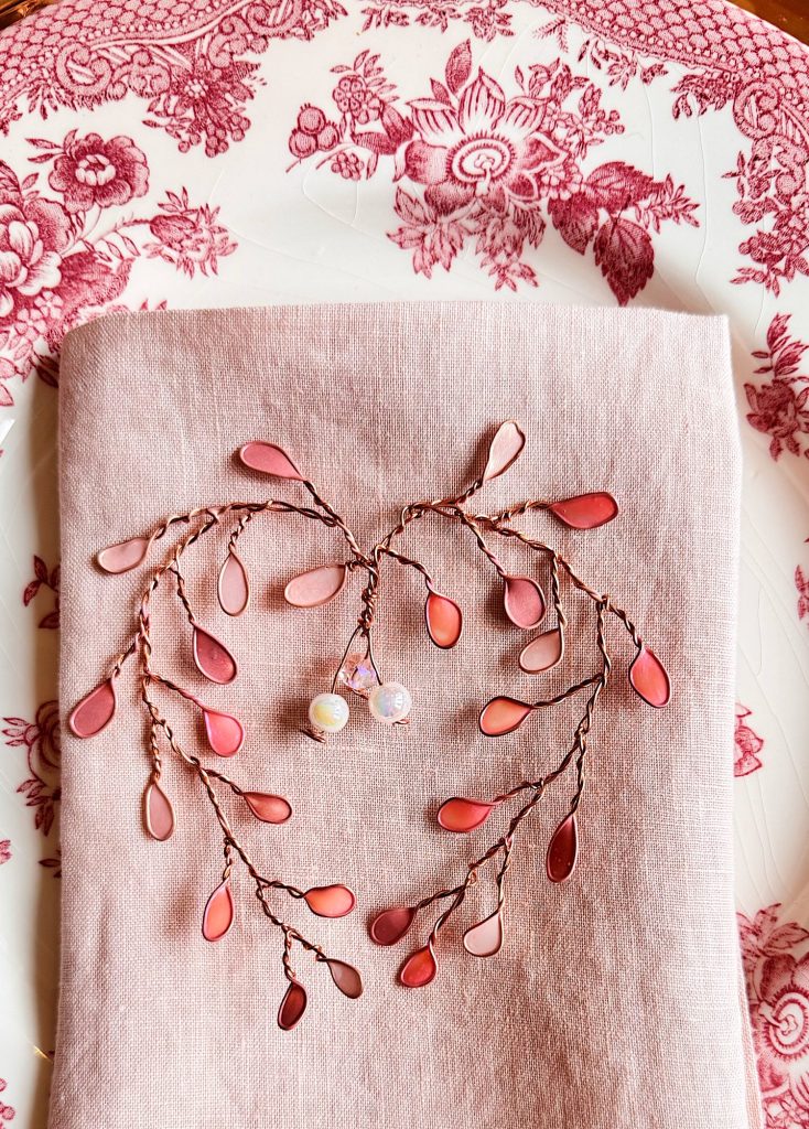 A pink napkin with a branch on it.