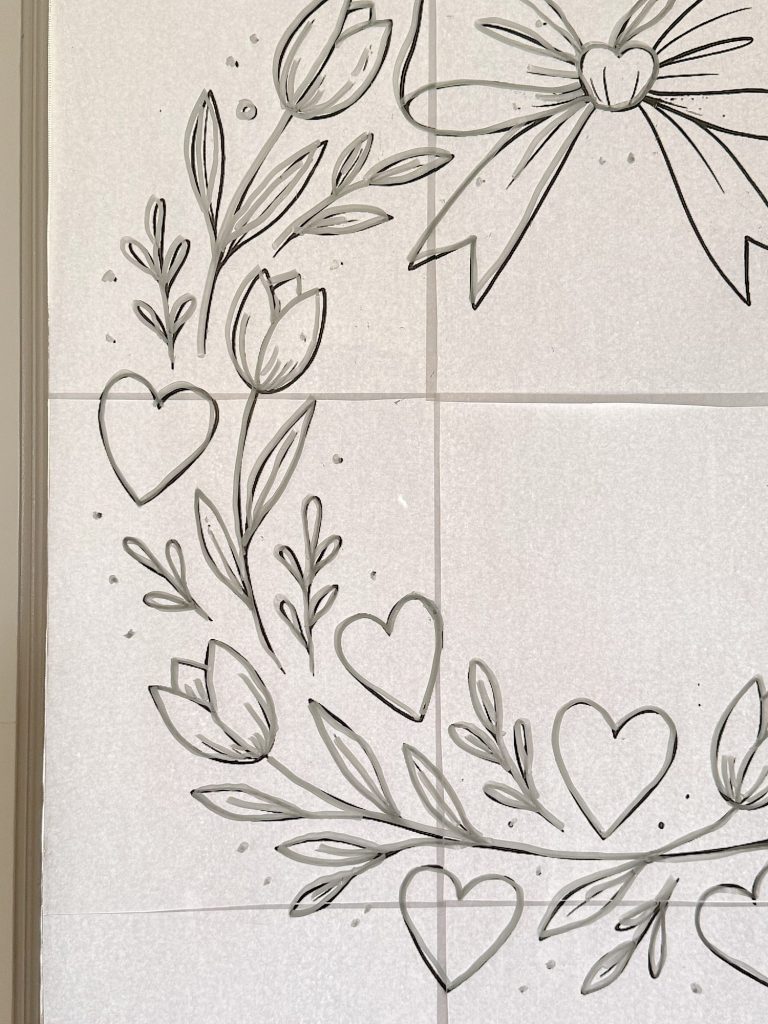 Black line drawing of tulips, leaves, and hearts forming a partial wreath with a bow on a light tiled background.