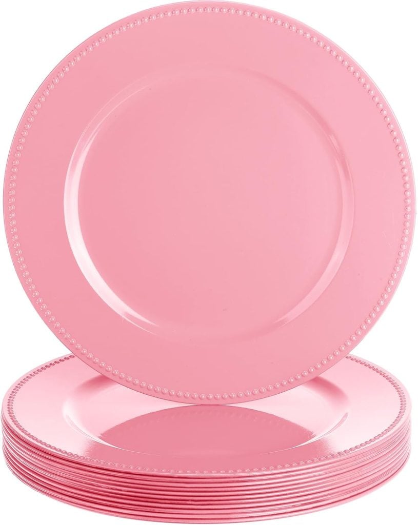 A stack of round, pink plates with a beaded edge design; one plate is standing upright, displaying its full face.