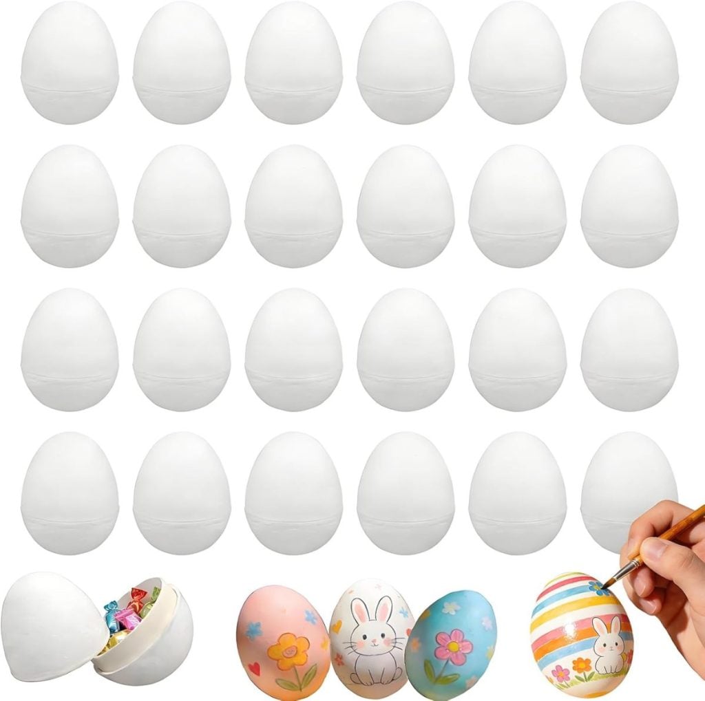 Twenty-four plain white plastic eggs in four rows, with four decorated eggs below; one is open with candy inside, three are hand-painted with various colorful designs.