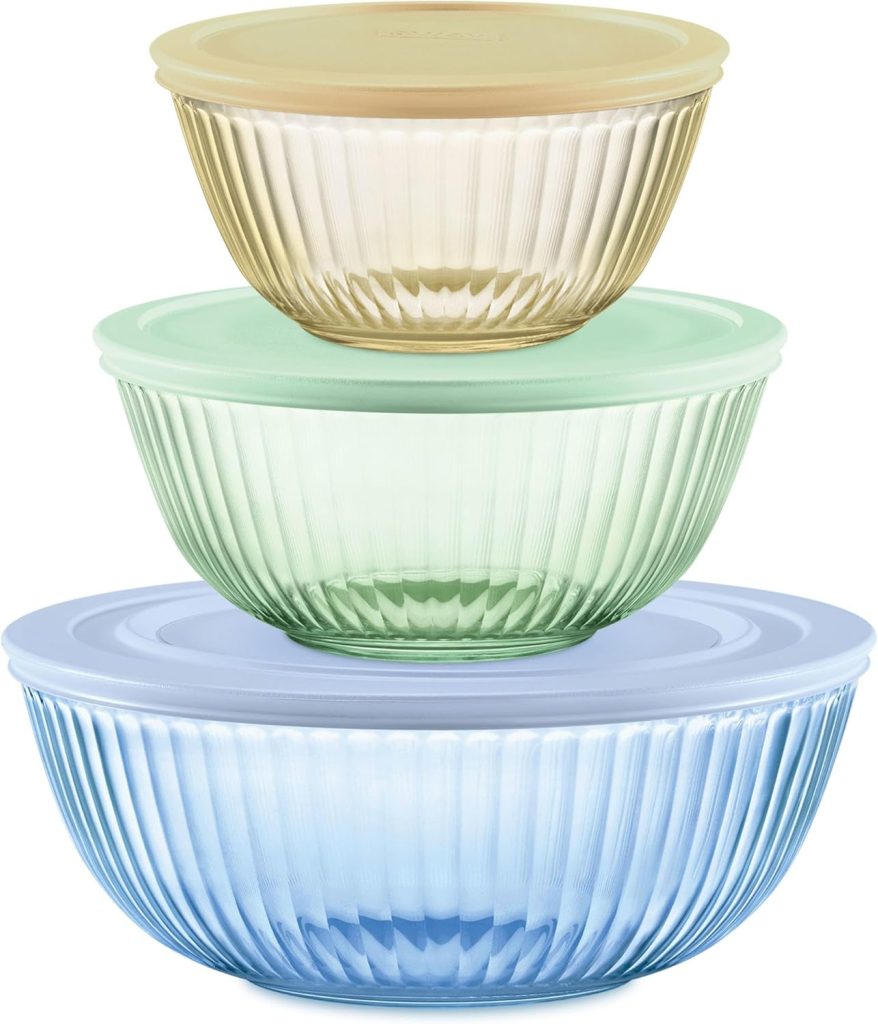 Three ribbed glass mixing bowls in yellow, green, and blue, stacked by size, each with a matching colored plastic lid.