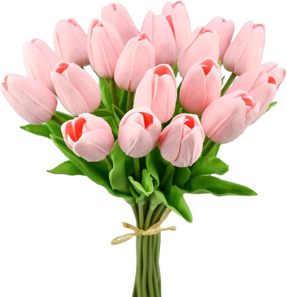 A bouquet of light pink tulips with green leaves and stems, tied together with a thin natural-colored string.