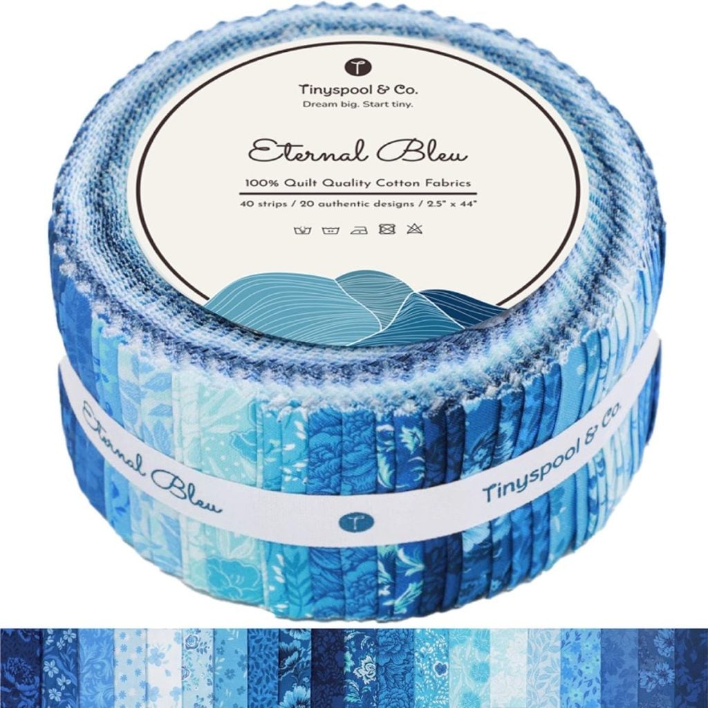 A rolled bundle of blue patterned cotton fabric strips labeled "Eternal Bleu" by Tinyspool & Co., with a row of the fabric designs displayed below.