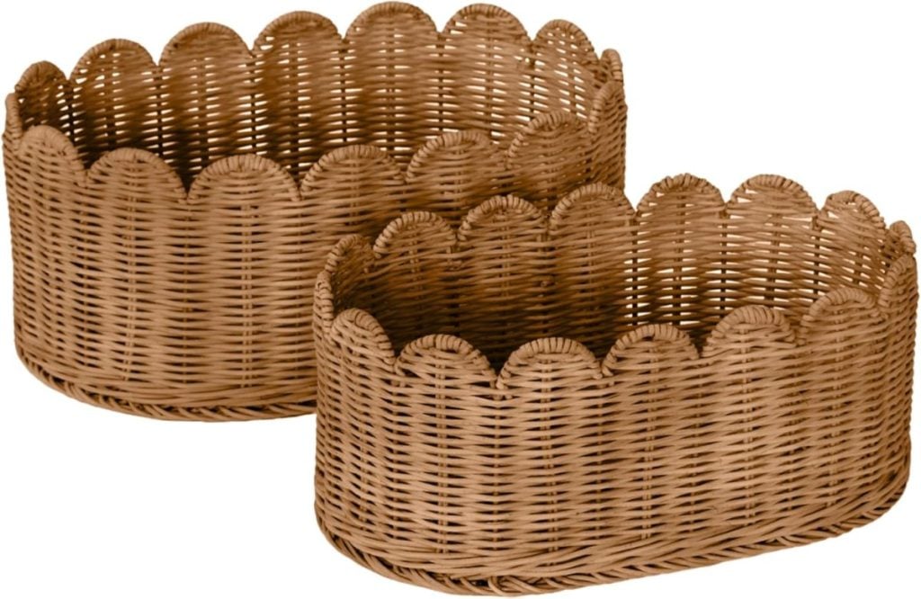 Two oval wicker baskets with scalloped edges are placed side by side.