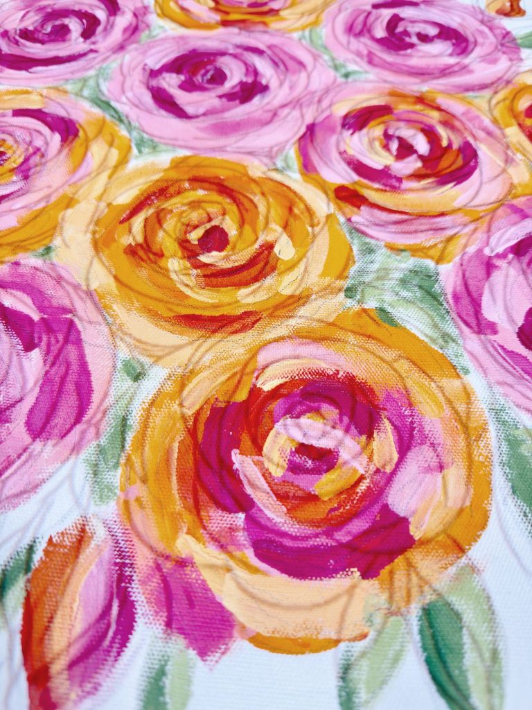 A close-up of a painting featuring clusters of pink, orange, and yellow roses with green leaves on a white background.