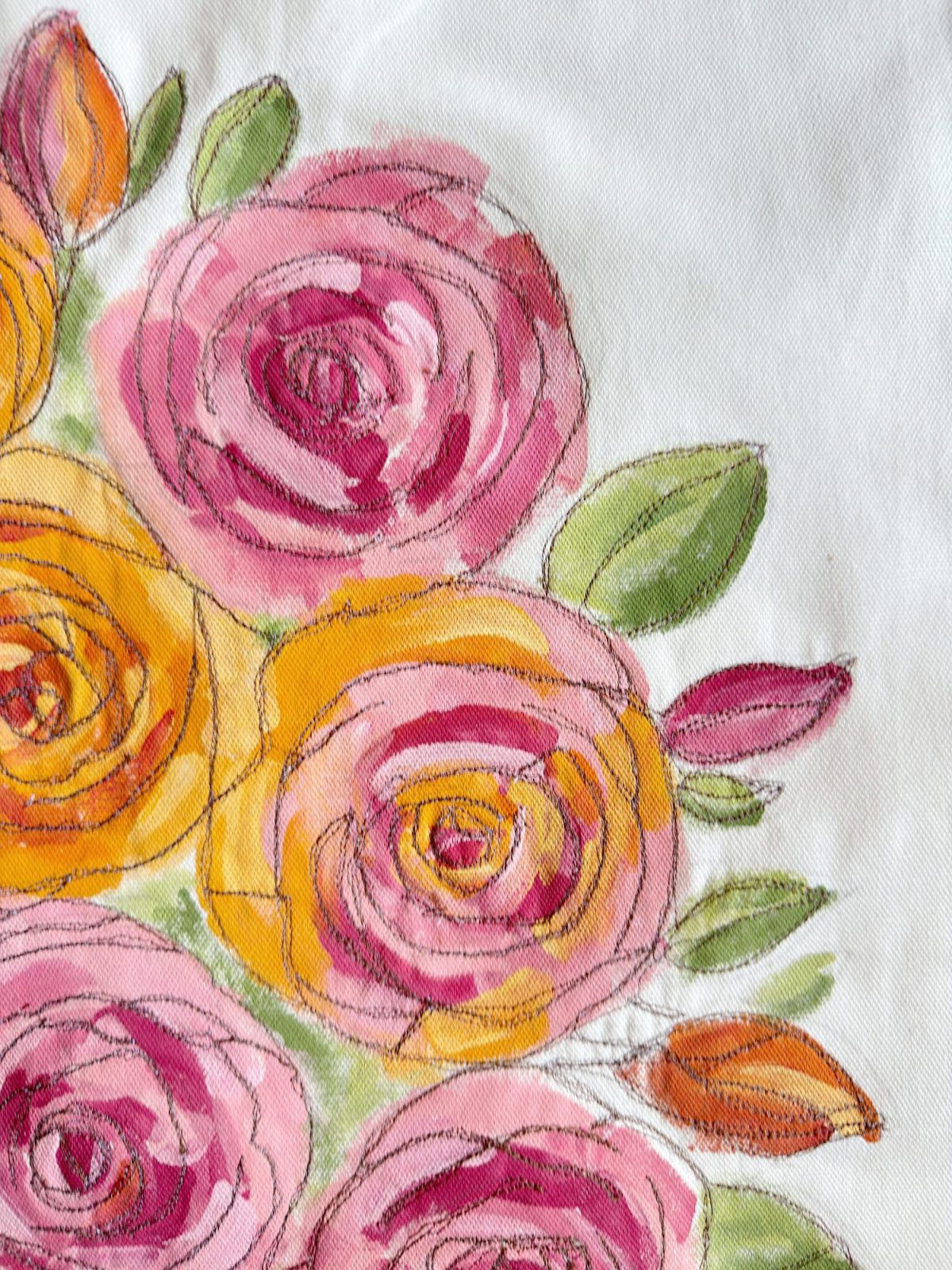A watercolor and ink illustration of pink and orange flowers with green leaves on a white fabric background.