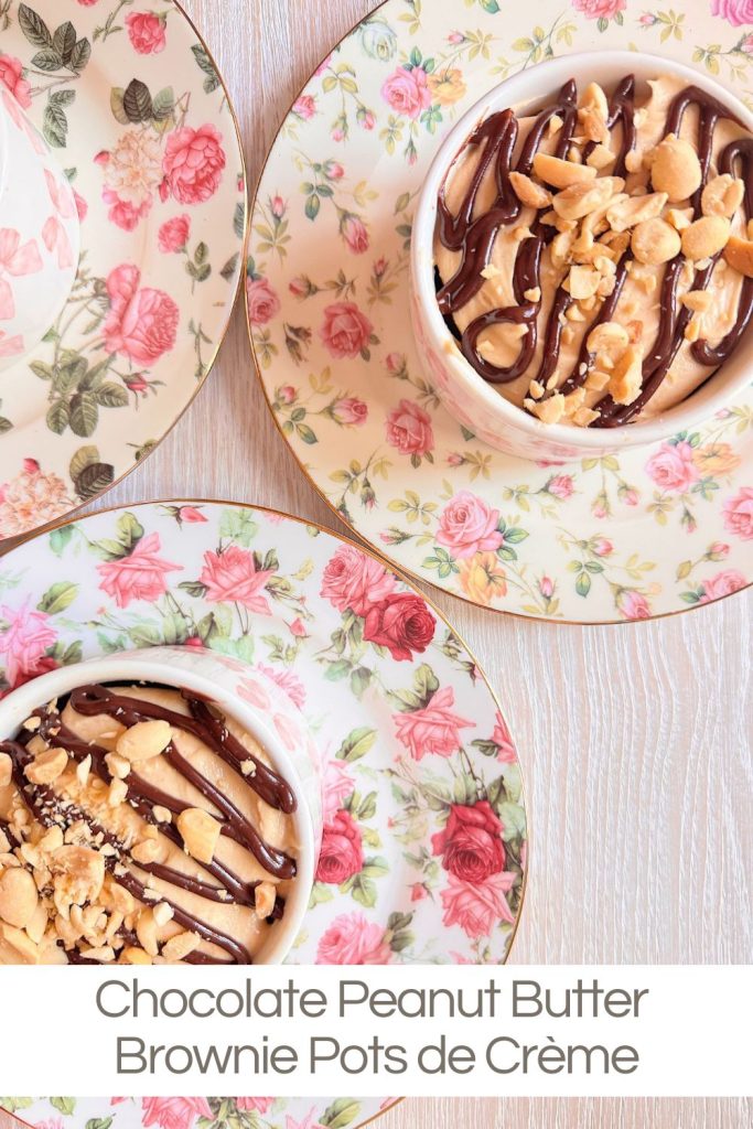 Two teacups on floral saucers filled with chocolate peanut butter brownie pots de cr&egrave;me, topped with chopped peanuts and chocolate drizzle.