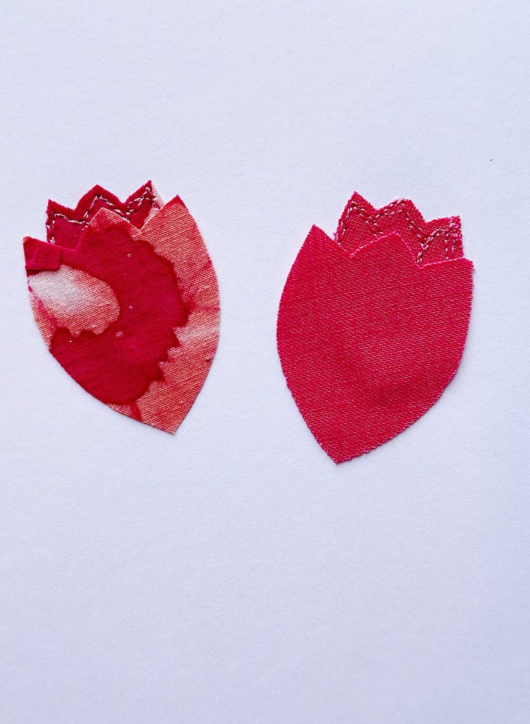 Two red fabric flower petals with pointed tops are placed side by side on a white background; the left petal is patterned, the right petal is solid red.