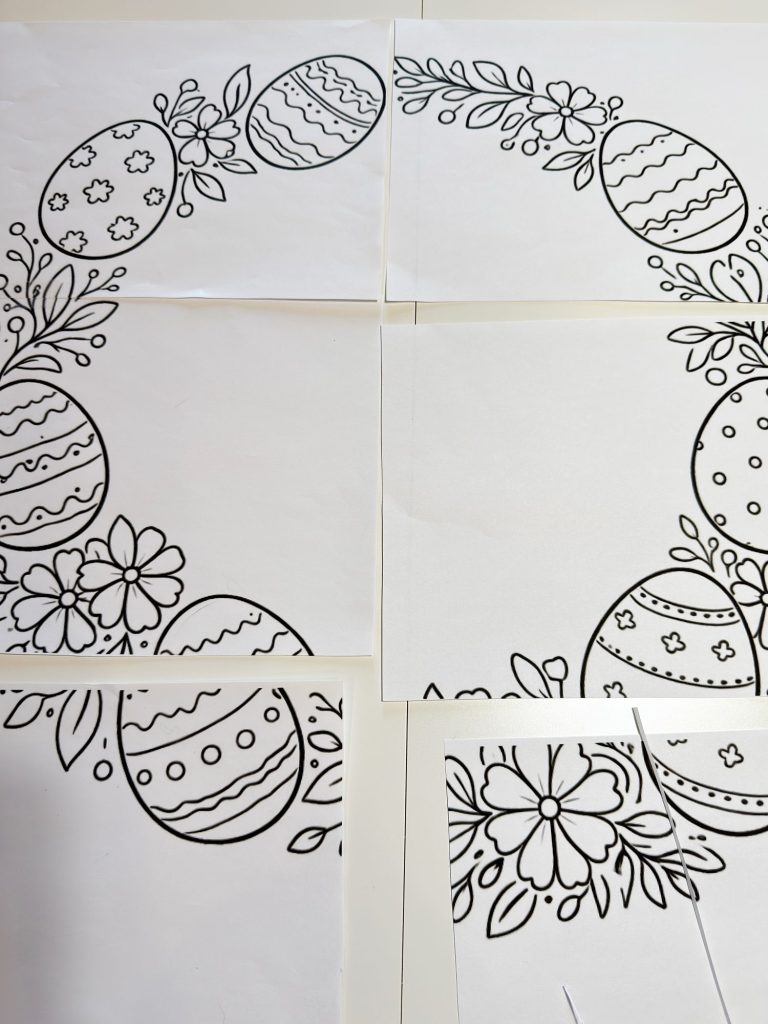 Black and white outlines of Easter eggs and flowers printed on multiple sheets of paper, arranged to form a larger, cohesive design.