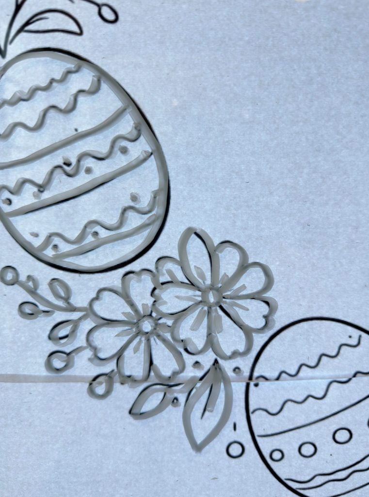 Line drawing of two decorated Easter eggs and three flowers with leaves on a light gray background.