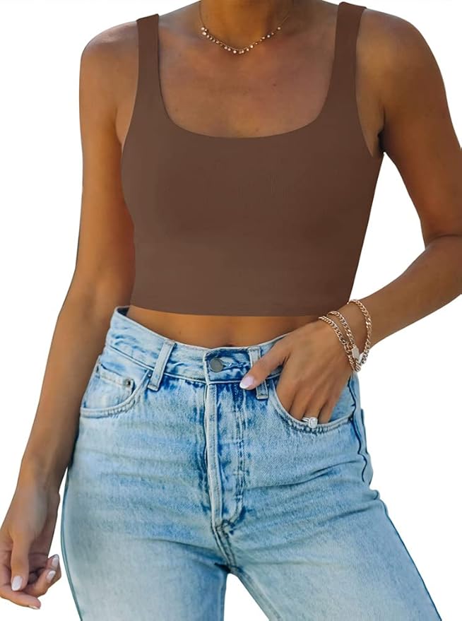 Woman wearing a brown sleeveless crop top and high-waisted light blue jeans, accessorized with a necklace and bracelets&mdash;perfect inspiration for your next look during the Amazon Big Spring Sale.